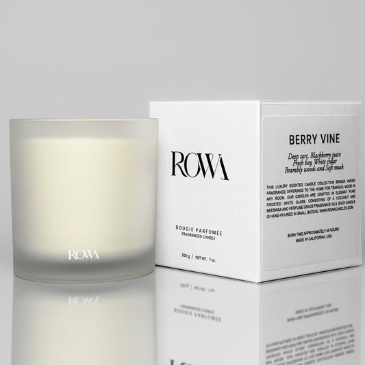 ROWA Berry Vine candle in frosted glass, styled with berries, green leaves, and warm wood tones to evoke a wild orchard atmosphere.