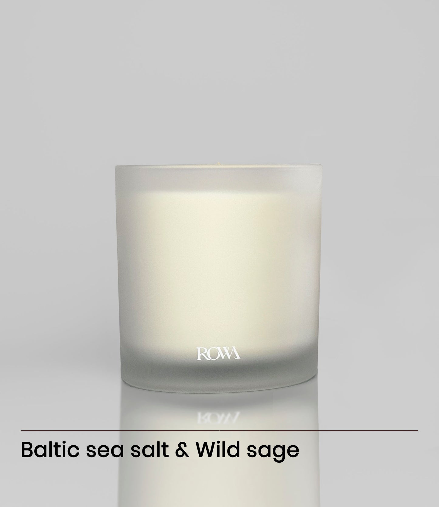ROWA Miles candle in frosted glass, styled with coastal tones and summer light to reflect its ocean-inspired scent of sea salt and sage.