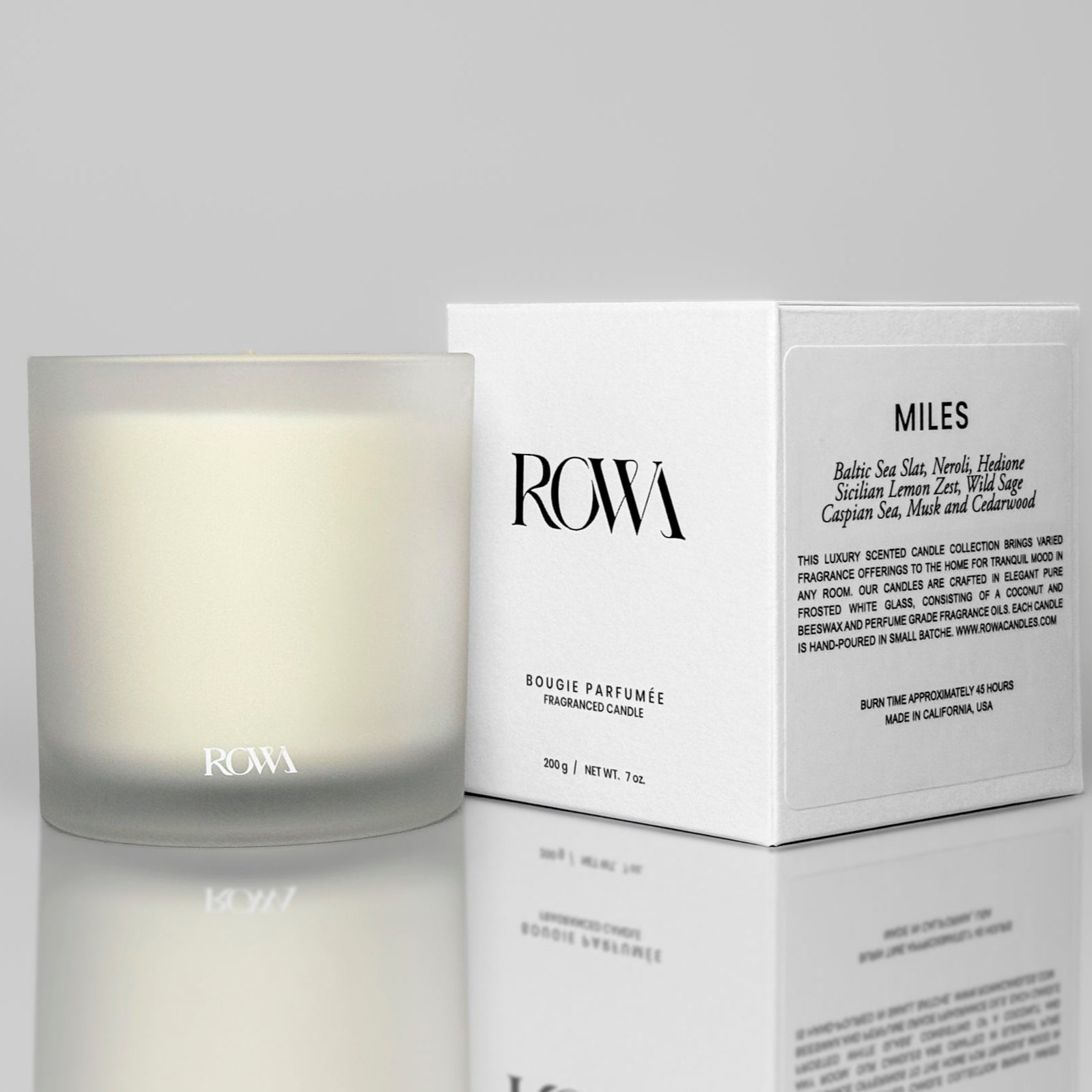 ROWA Miles candle in frosted glass, styled with coastal tones and summer light to reflect its ocean-inspired scent of sea salt and sage.
