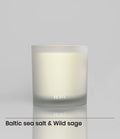 ROWA Miles candle in frosted glass, styled with coastal tones and summer light to reflect its ocean-inspired scent of sea salt and sage.
