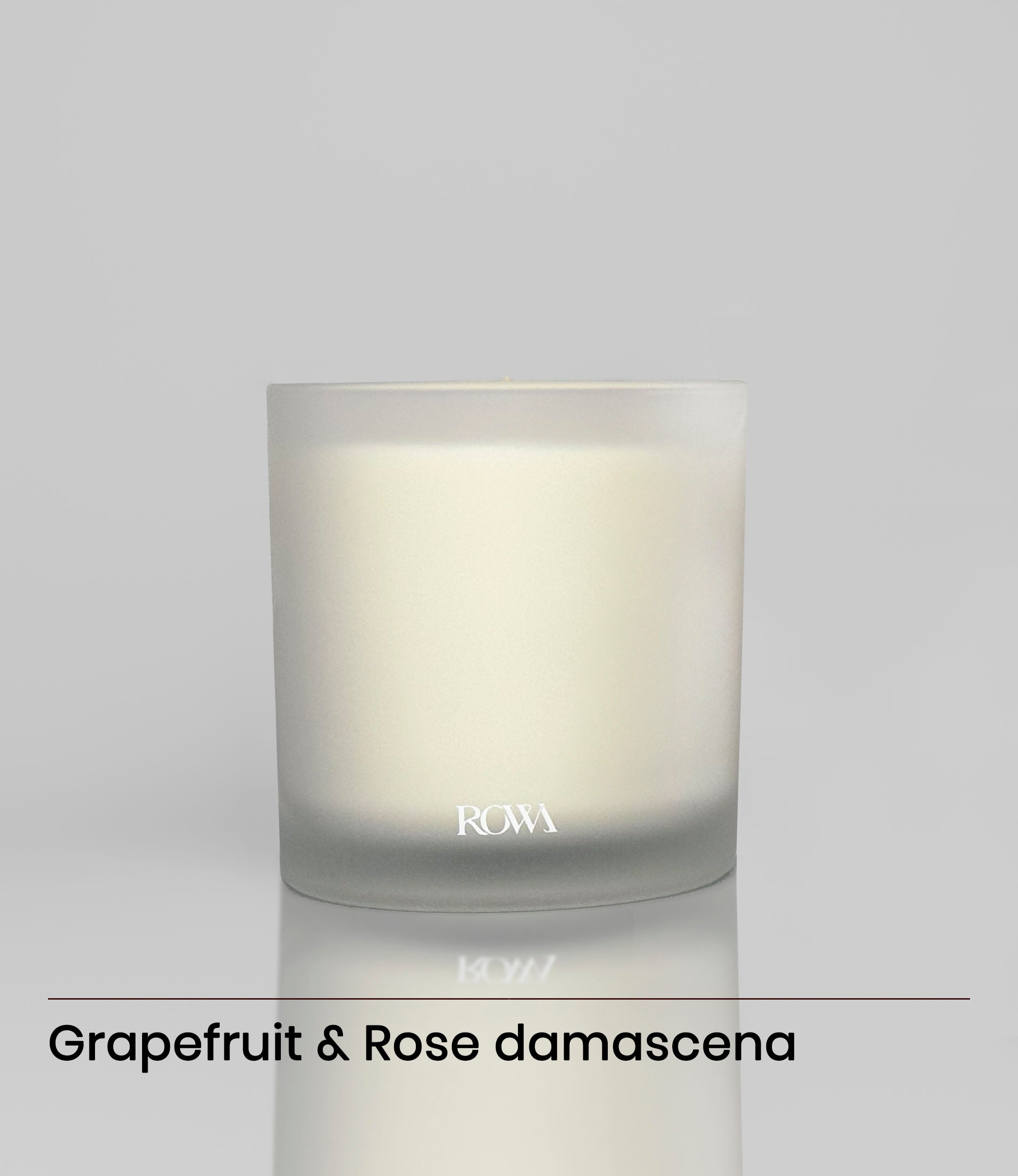 ROWA Rose candle in a frosted glass jar, surrounded by soft petals and greenery, styled to evoke a rainy day rose garden atmosphere.
